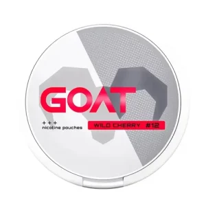 A top-down view of the circular lid for GOAT Wild Cherry Snus nicotine pouches. The design features a modern, split background with smooth white on the left and a grey dotted texture on the right, overlaid with a large, geometric grey silhouette of a goat's head. The brand name "GOAT" appears in bold, vibrant red typography across the centre, visually evoking the luscious and vibrant sweetness of the ripe cherry flavour profile. A red rectangular badge below the logo reads "WILD CHERRY #12," corresponding to the 12mg per gram nicotine content. To the left, three plus signs ("+++") and the text "nicotine pouches" indicate the product type and strength level.
